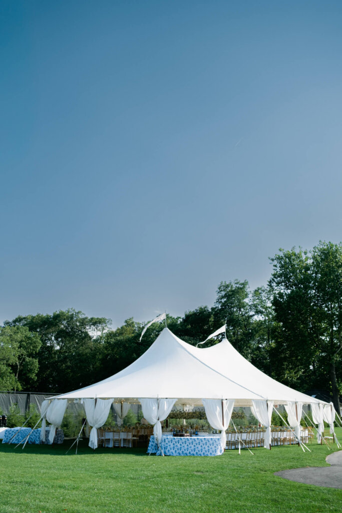 Inside the reception tent at Bedford Golf and Tennis Club with blue and white flowers