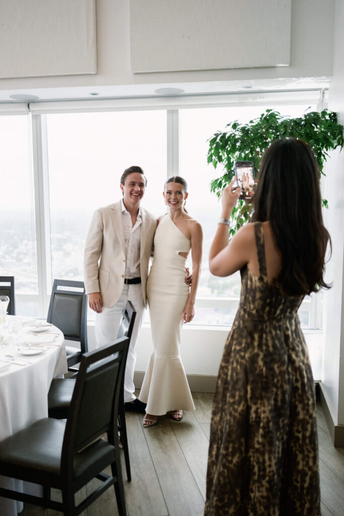 Louise and James laughing with guests at their New York welcome dinner