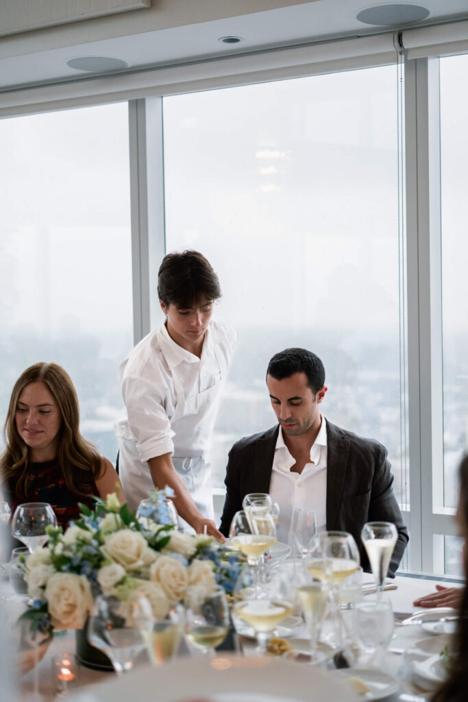 Guests seated for dinner during Louise and James’ New York welcome dinner