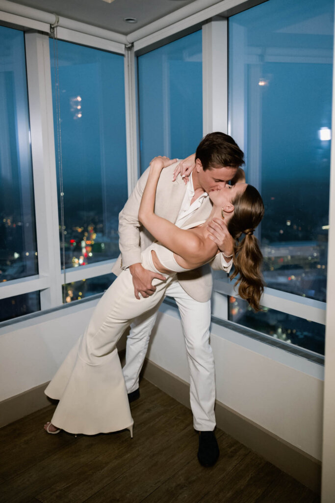 Louise and James sharing a nighttime dip kiss at their New York welcome dinner