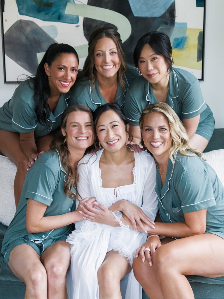 Tiffany with her bridesmaids in matching green pajamas before the wedding