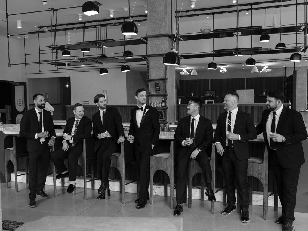 Tim with his groomsmen in black tuxedos before the wedding