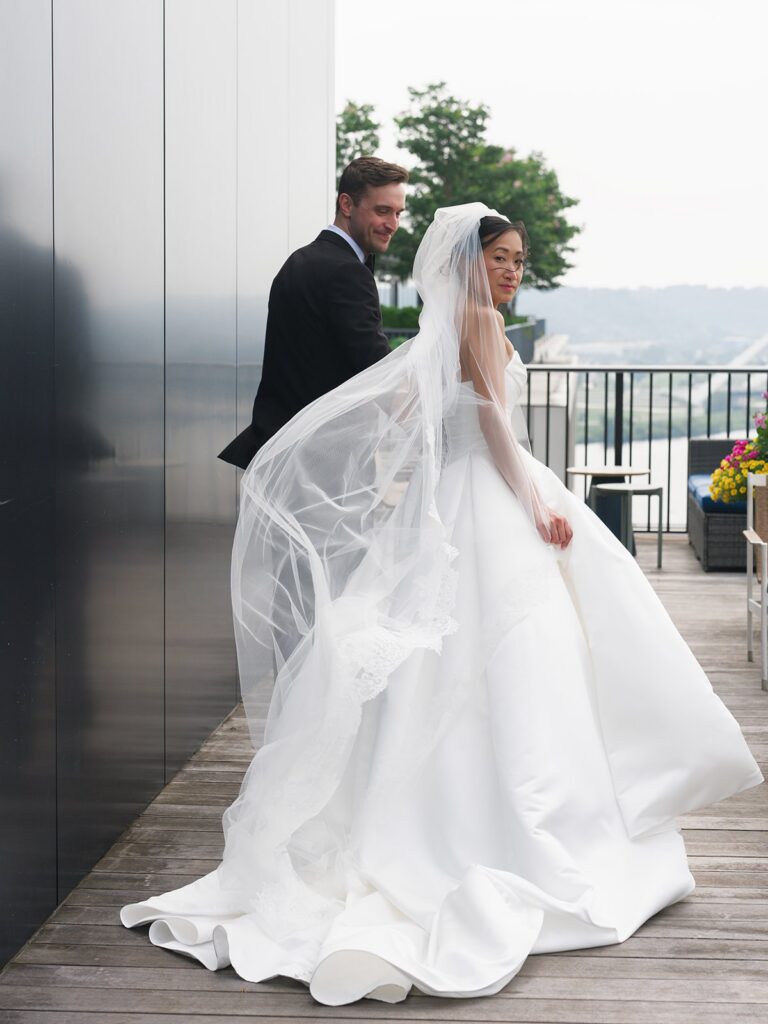 Tiffany and Tim walking together on a Navy Yard terrace after their wedding first look