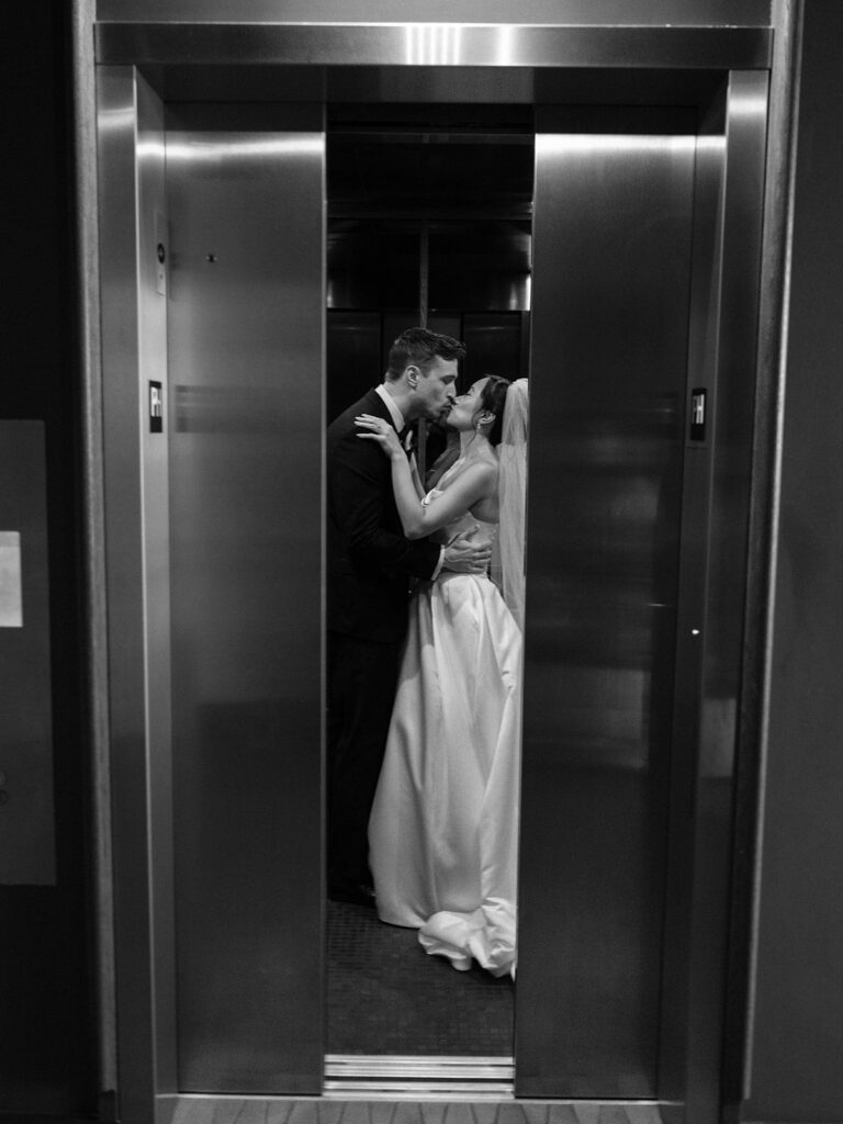 Tiffany and Tim kissing inside an elevator after their District Winery wedding ceremony