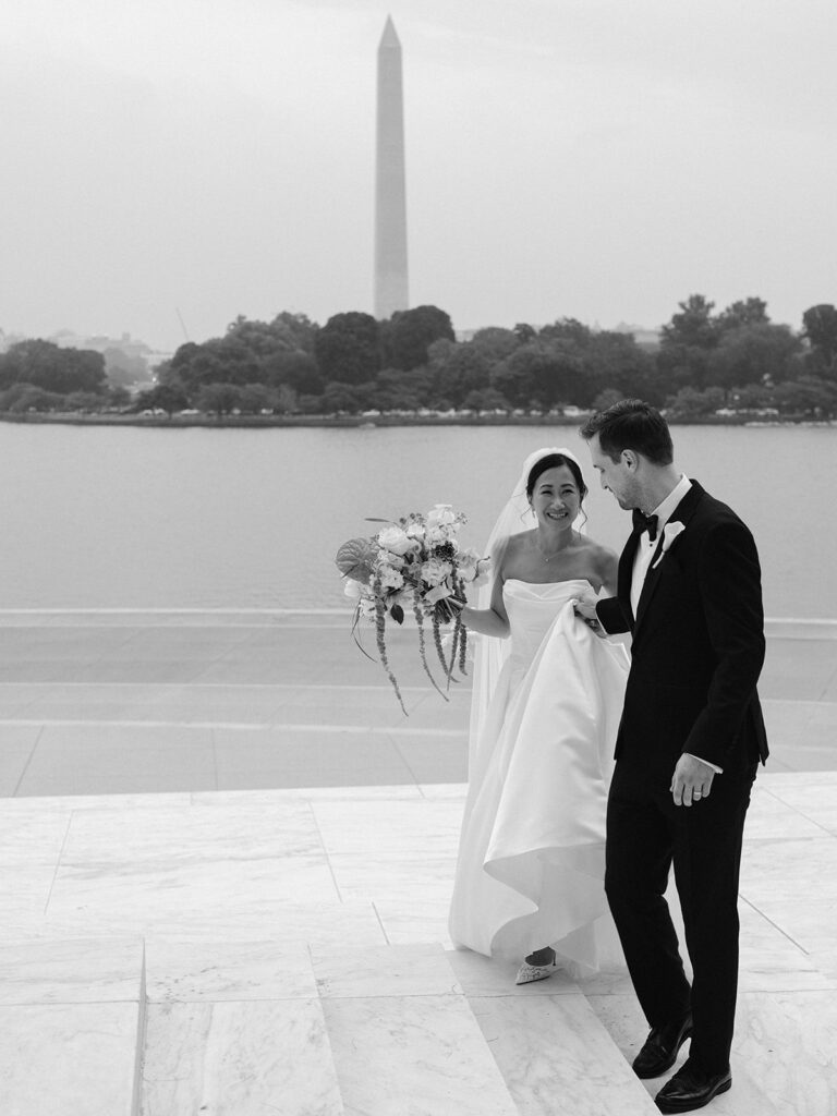 Tiffany and Tim walking at the Jefferson Memorial with the Washington Monument across the Tidal Basin