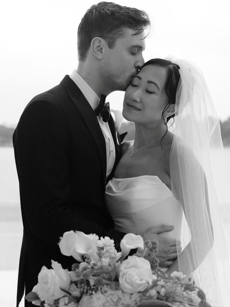 Tim kissing Tiffany's forehead during portraits at the Jefferson Memorial