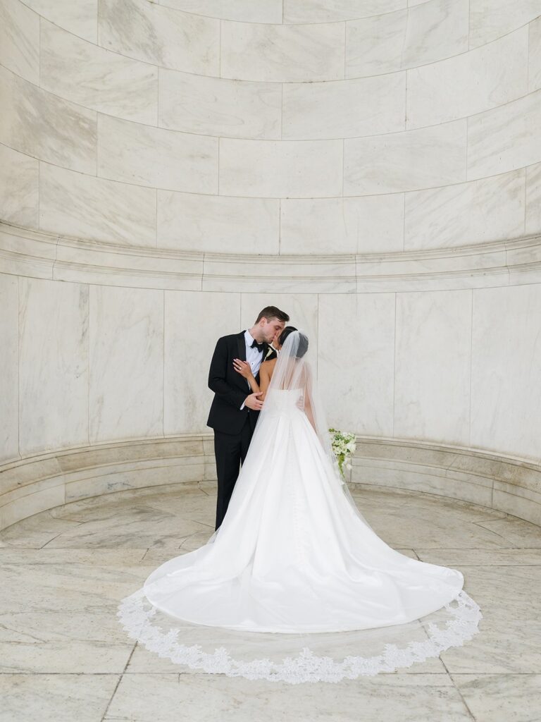 Tiffany and Tim kissing beneath the curved interior of the Jefferson Memorial