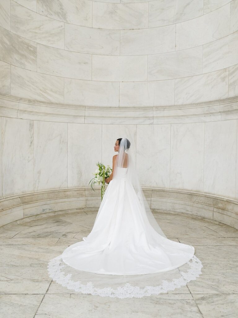 Tiffany's lace-edged veil spread across the marble floor of the Jefferson Memorial