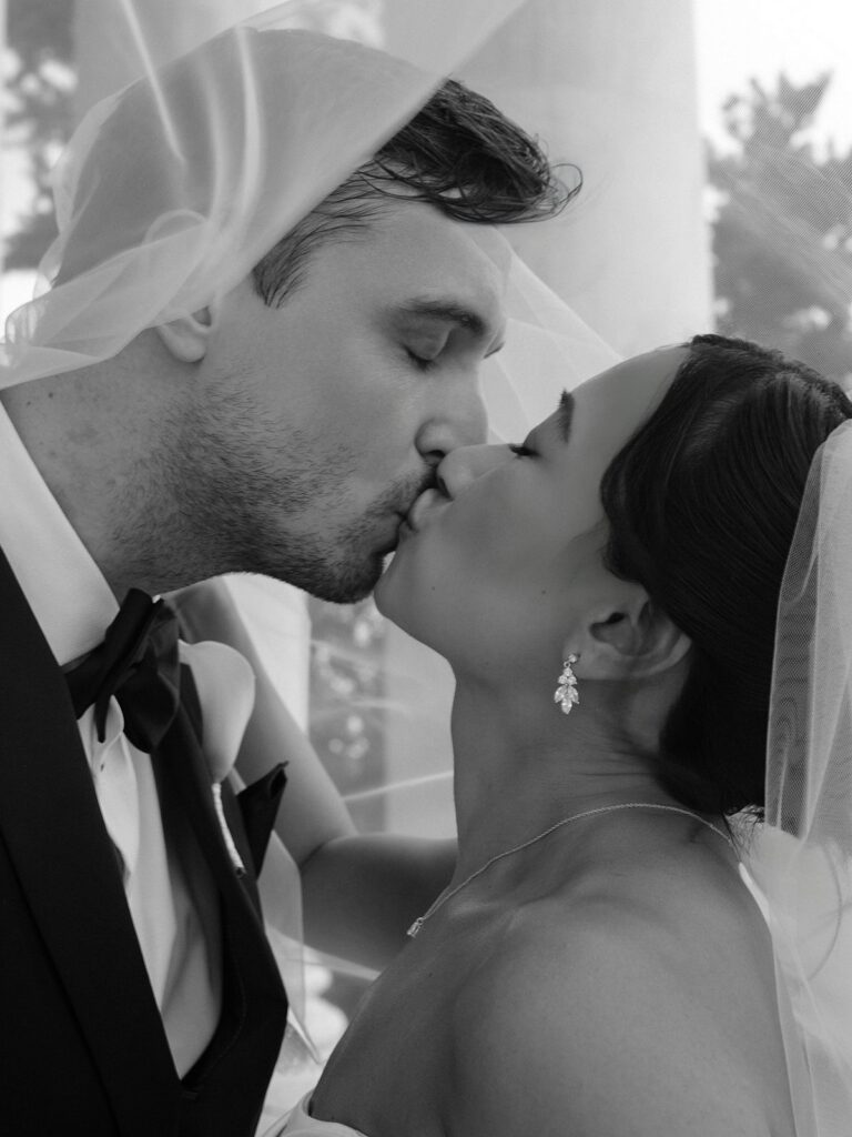 Close black-and-white portrait of Tiffany and Tim kissing at the Jefferson Memorial