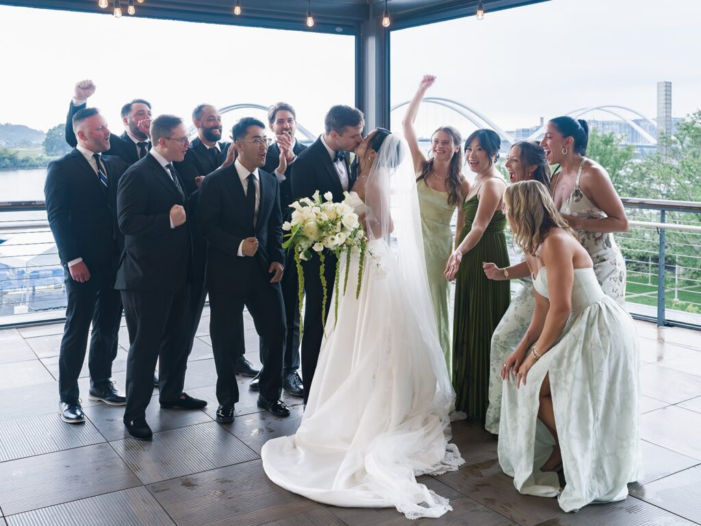 Wedding party cheering around Tiffany and Tim at District Winery