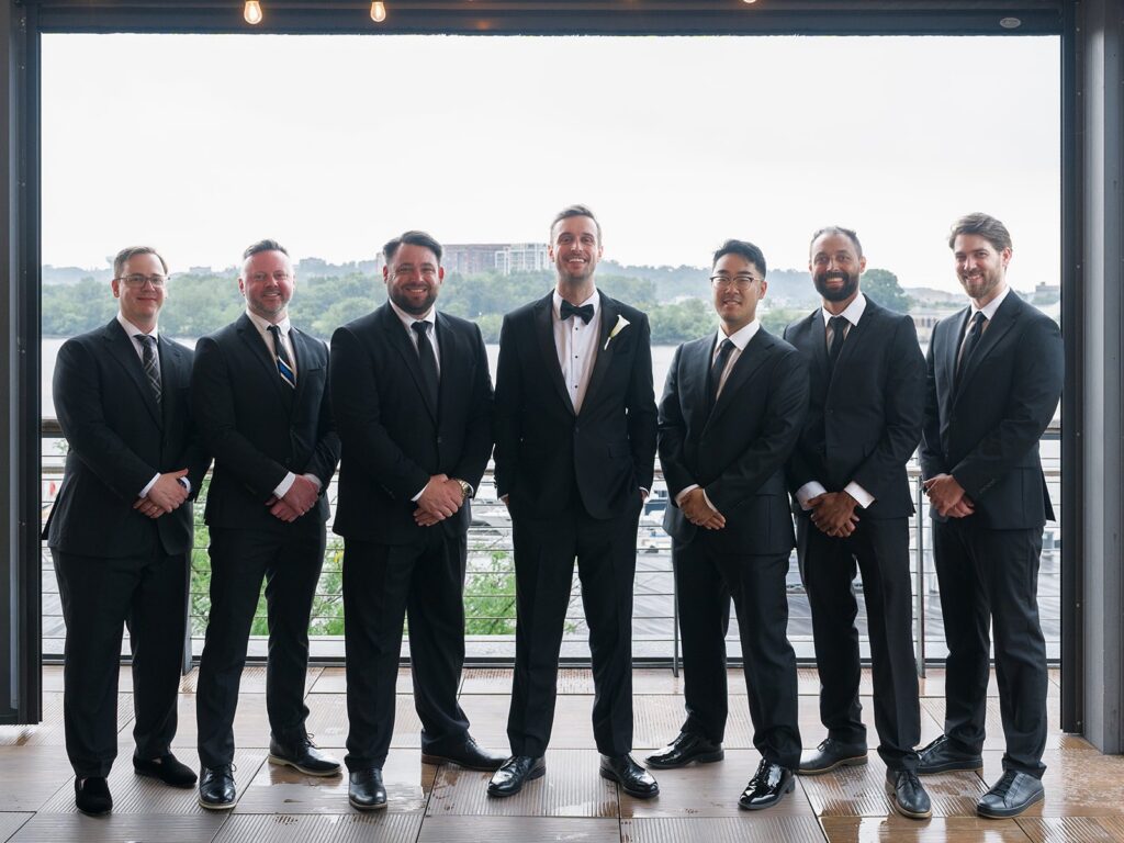 Tim with his groomsmen in front of the District Winery windows