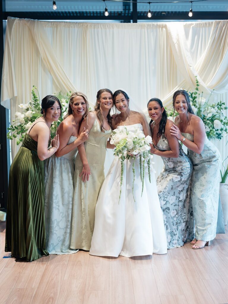 Tiffany with her bridesmaids in green and floral dresses