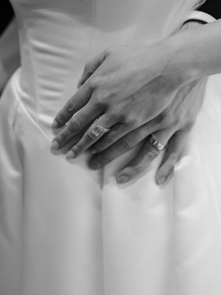 Tiffany and Tim holding hands with their wedding rings visible