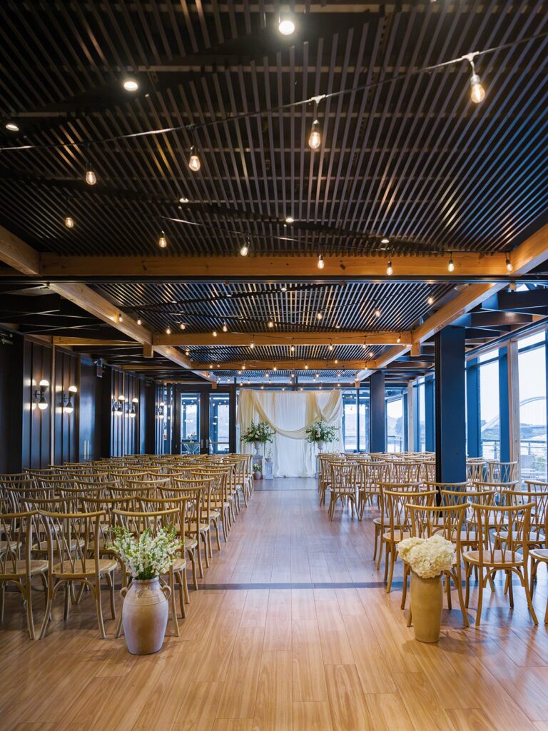District Winery ceremony room with white draping and green-and-white flowers