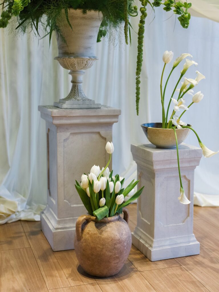 White tulips and floral urns at a District Winery wedding ceremony