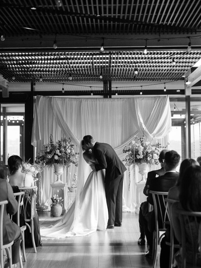 Tiffany and Tim sharing their first kiss during the ceremony