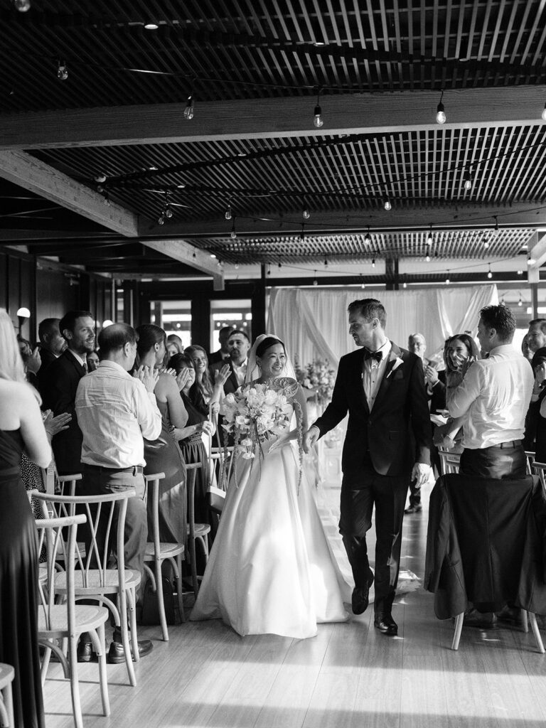 Tiffany and Tim walking back up the aisle after their wedding ceremony
