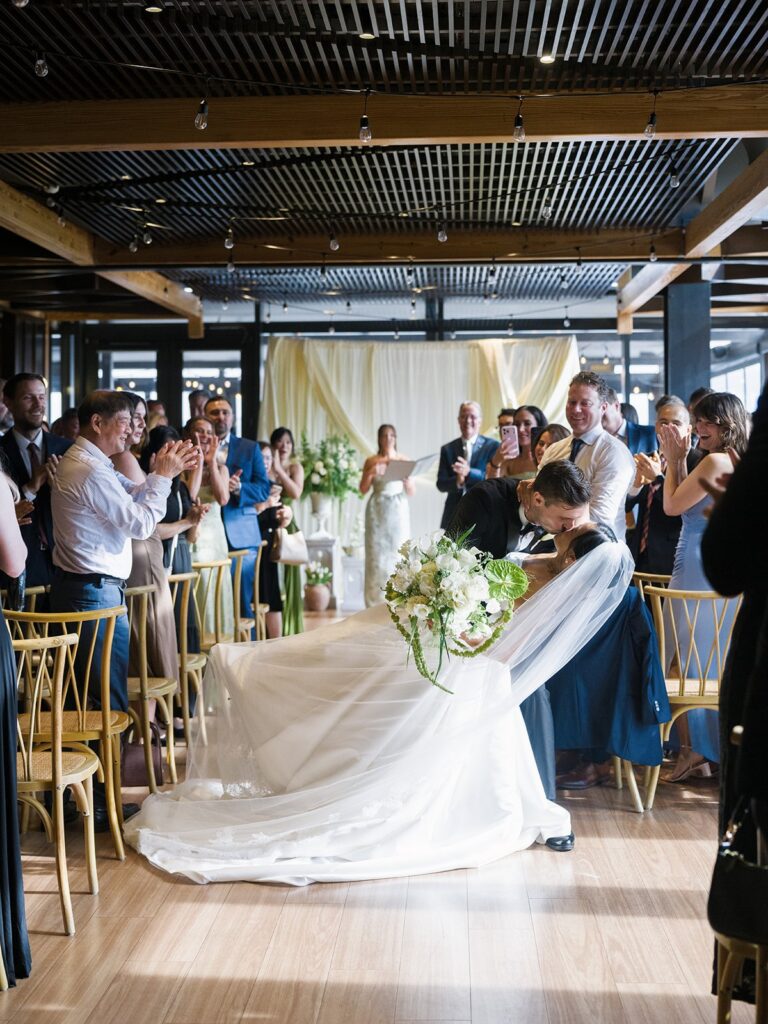Tiffany and Tim exiting their District Winery ceremony as guests cheer