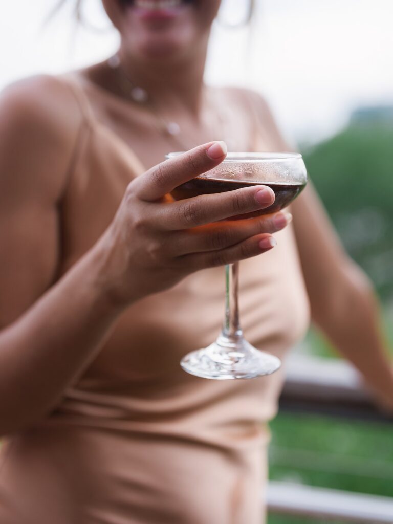 Tiffany holding a cocktail during the District Winery patio reception