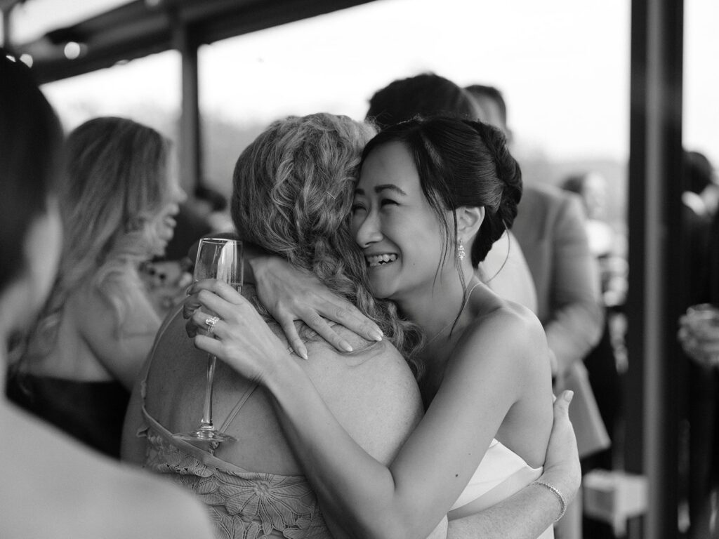 Tiffany embracing a guest during District Winery cocktail hour