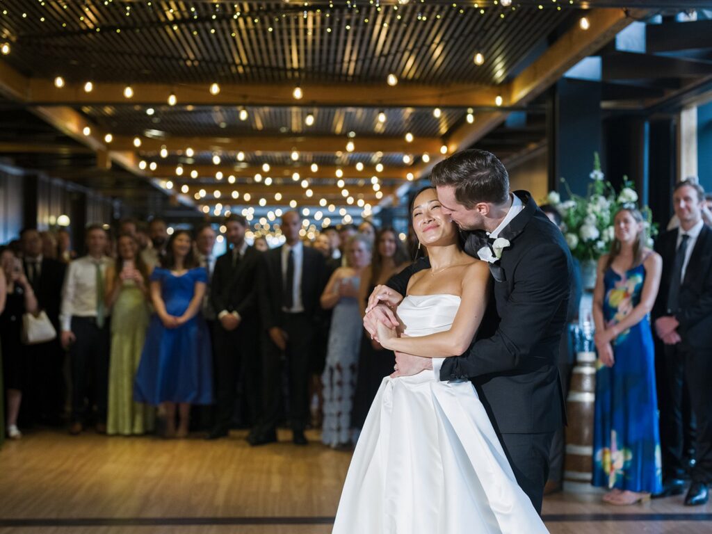 Tiffany and Tim sharing their first dance under string lights