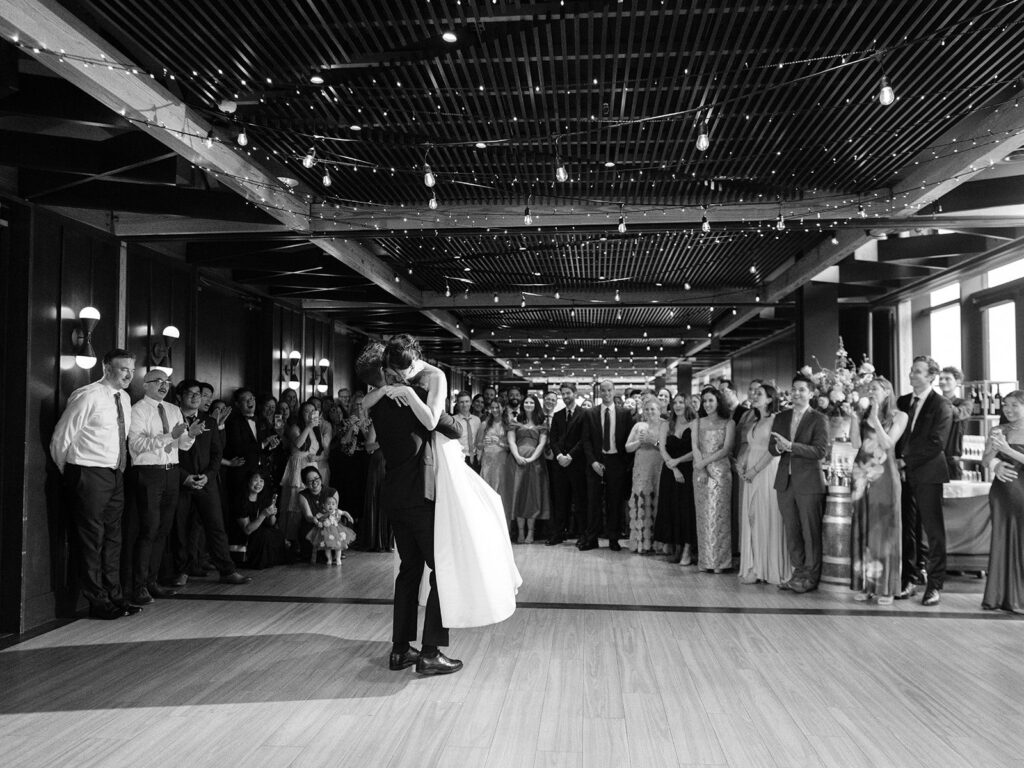 Wide black-and-white view of Tiffany and Tim's first dance