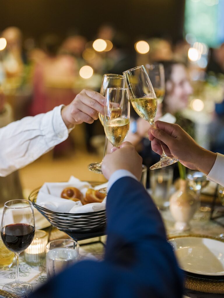 Wedding guests toasting over dinner at District Winery