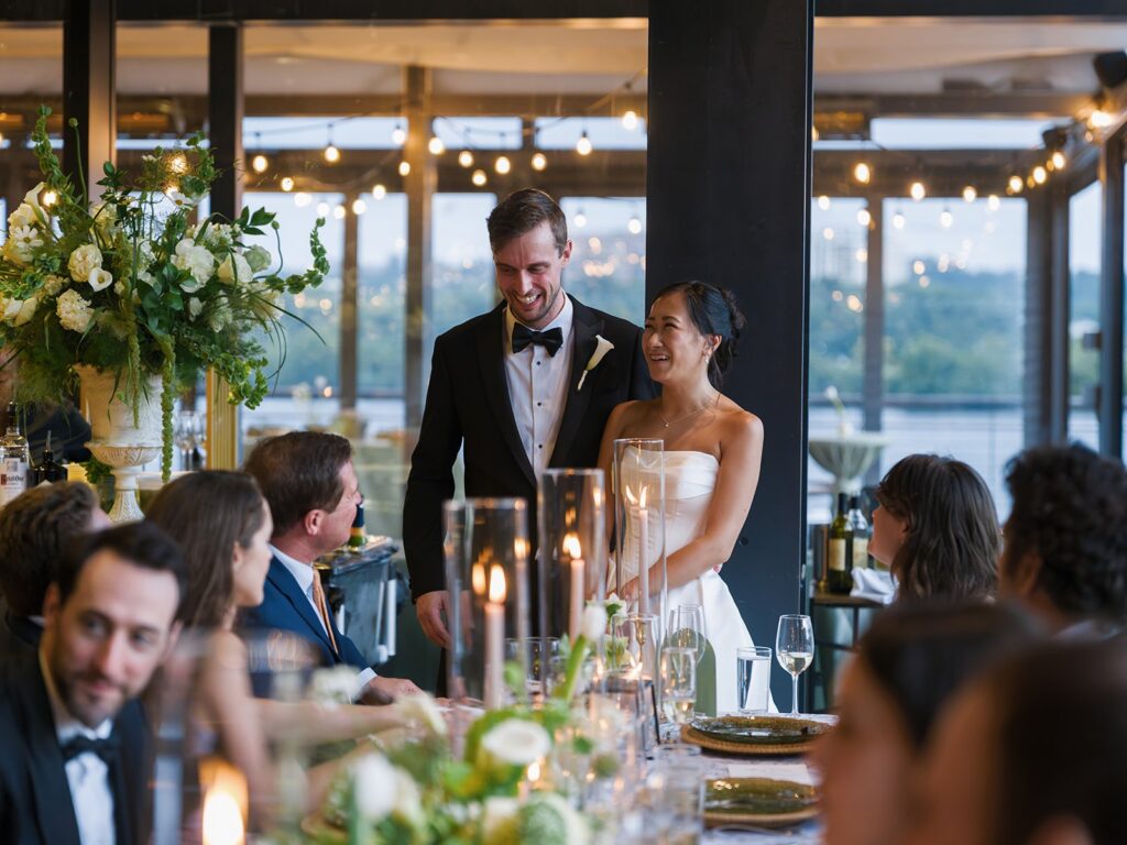 Tiffany and Tim standing together during a reception speech