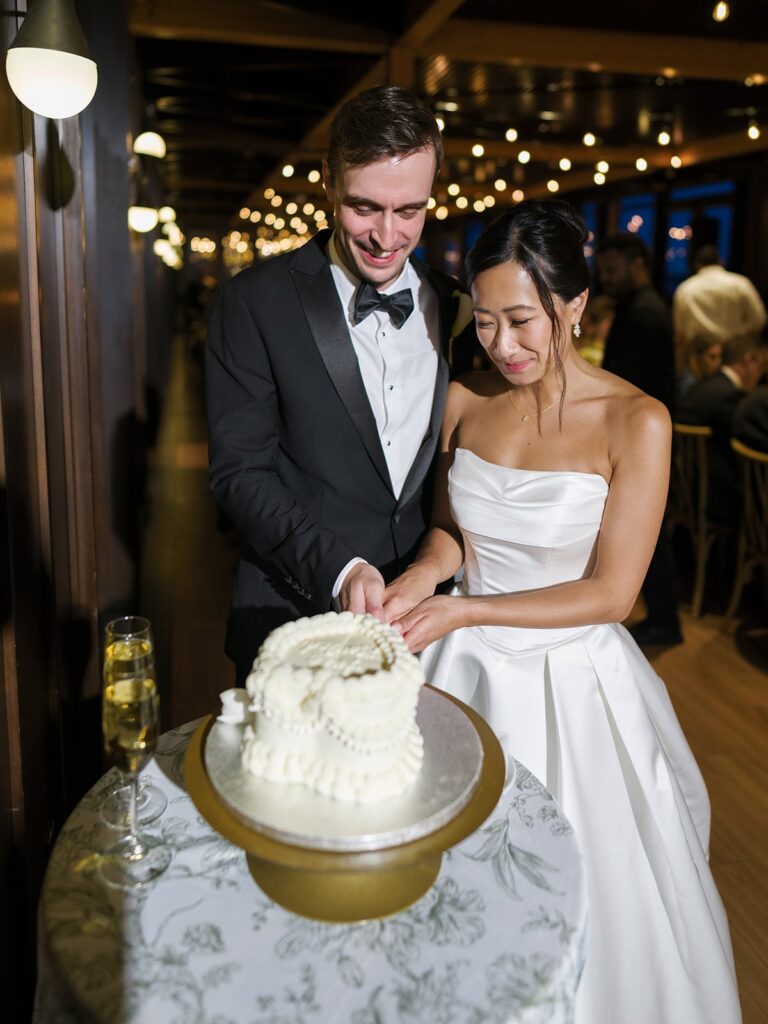 Tiffany and Tim cutting their wedding cake together