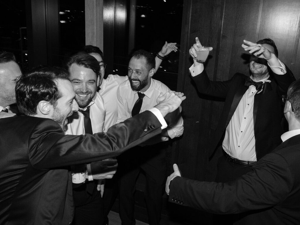 Groomsmen celebrating together on the dance floor