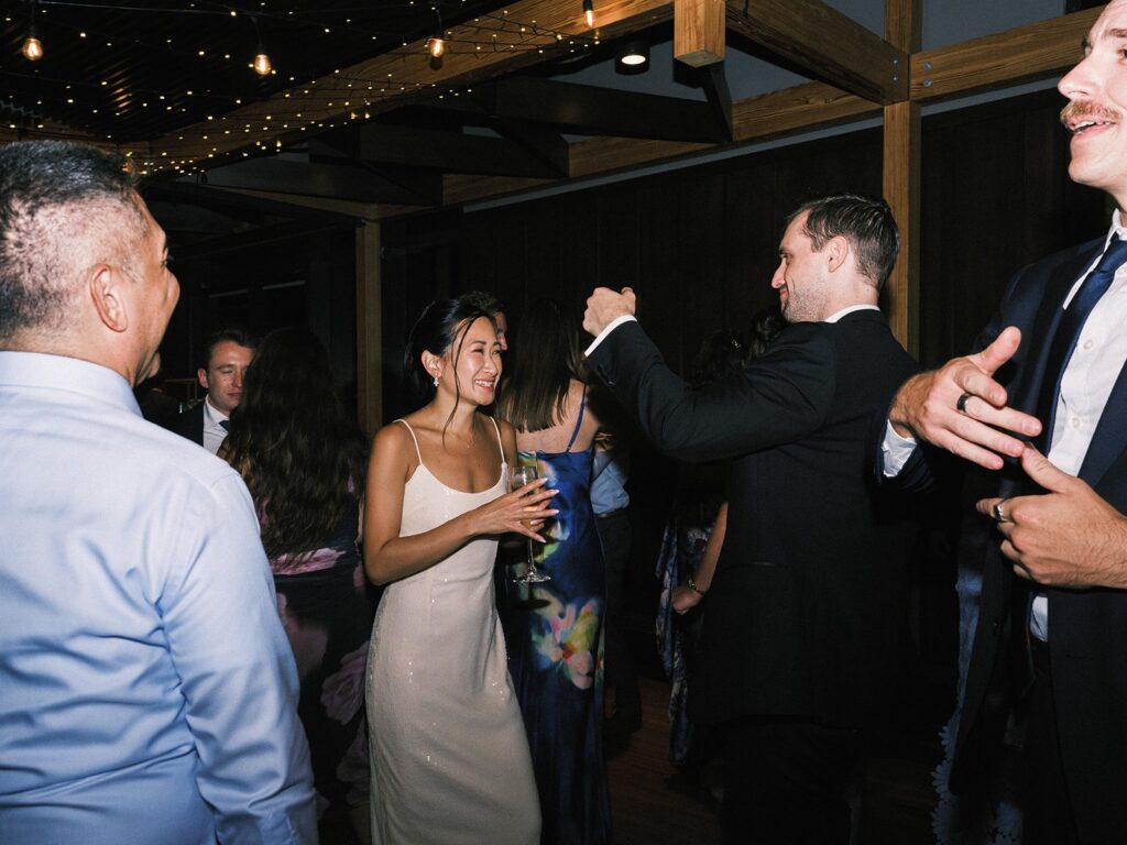 Tiffany dancing with a guest at the wedding reception