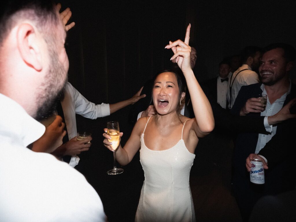 Tiffany cheering on the crowded wedding dance floor