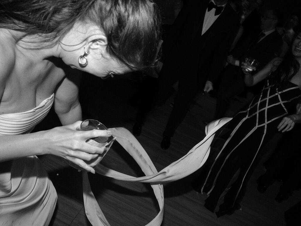 Black-and-white candid of guests dancing at the reception
