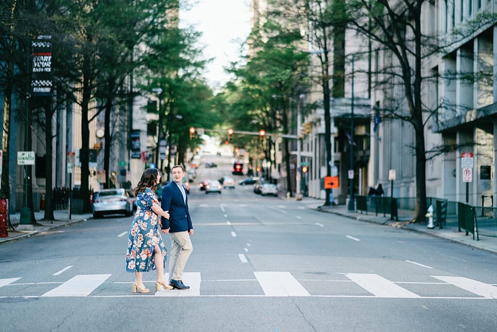 Romantic moment captured crossing the street on 10th street during engagement session in Richmond