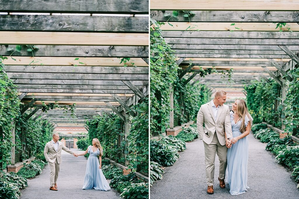 Engaged couple walking hand-in-hand through Biltmore's Walled Garden