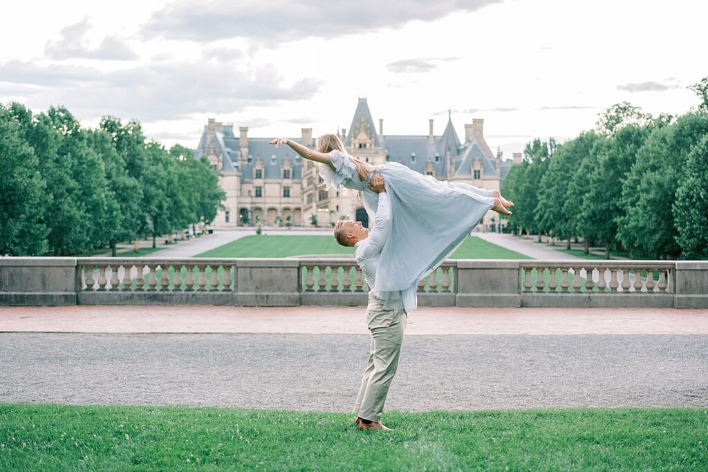 Couple dirty dance lift at Biltmore's Esplanade during their Biltmore Estate Engagement Session