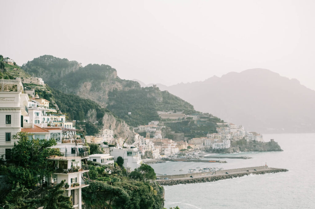 A sweeping view of Amalfi’s hillside buildings and coastline, highlighting the region’s iconic Mediterranean charm of the Amalfi Coast.