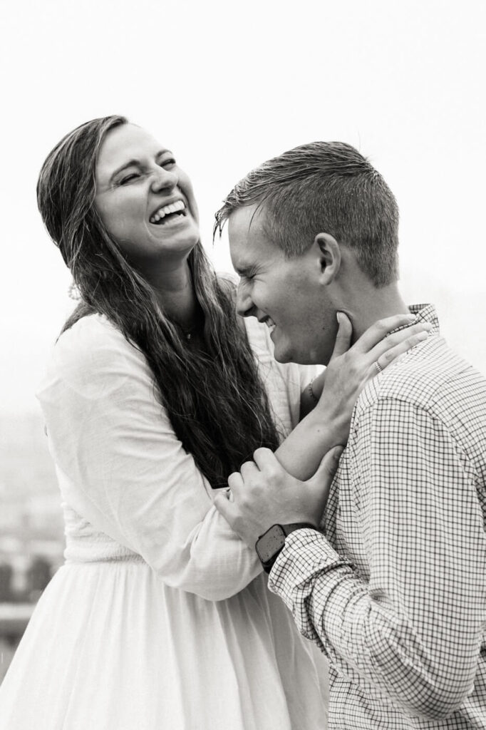 Genuine laughter between a couple in Florence – A close-up black-and-white image of the couple laughing together, capturing pure joy during their destination session.