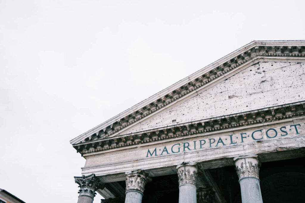 Pantheon architectural detail – A close-up view of the Pantheon’s facade, showcasing its ancient Latin inscription and weathered stonework, a testament to Rome’s enduring beauty.