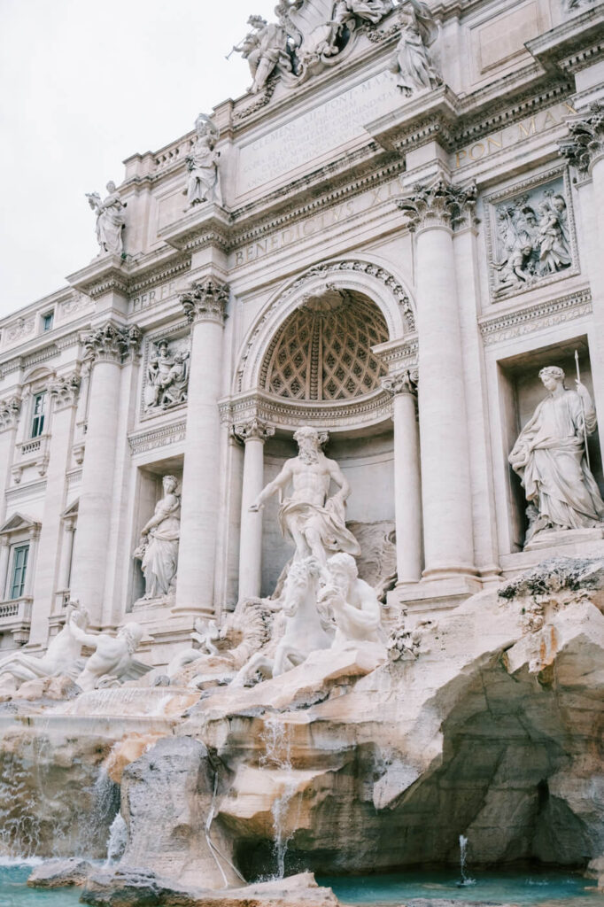 Trevi Fountain in Rome – A detailed shot of the Trevi Fountain’s grand Baroque design, featuring statues of Oceanus and mythological figures with flowing water, a masterpiece of Roman artistry.