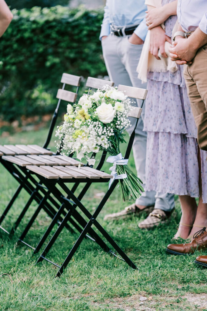 A touching tribute—a bouquet of white roses and baby's breath rests on a chair in honor of a loved one.