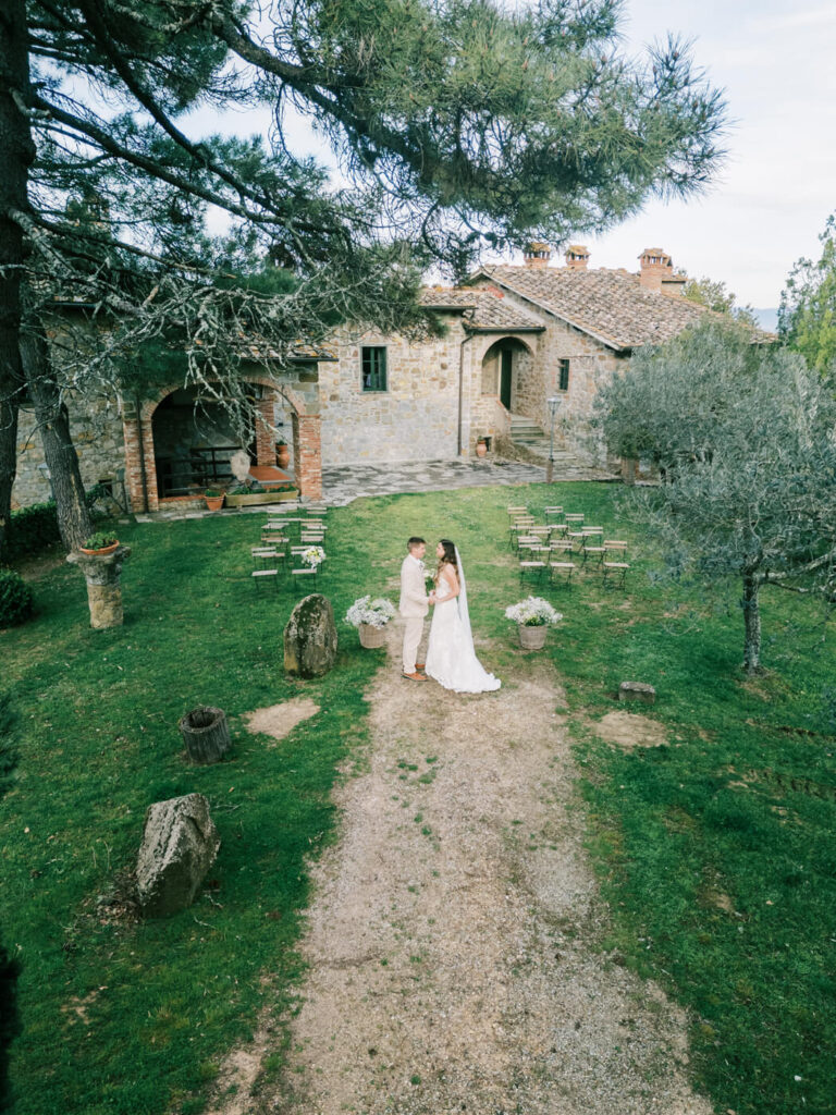 An intimate moment before the ceremony at Villa Olimpia – The bride and groom stand hand-in-hand in the villa’s garden, soaking in the peaceful surroundings before exchanging vows.