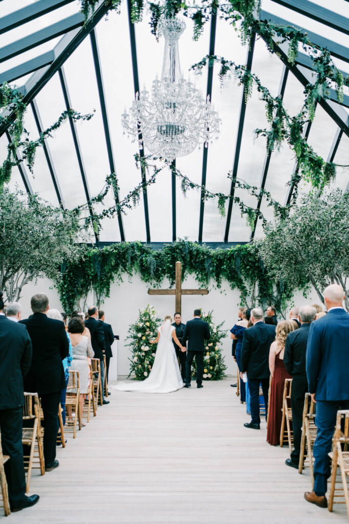 Bride and groom sharing a private moment at Greenhouse Two Rivers – A romantic aerial view of the newlyweds standing in the courtyard of Greenhouse Two Rivers, embracing during their wedding day.