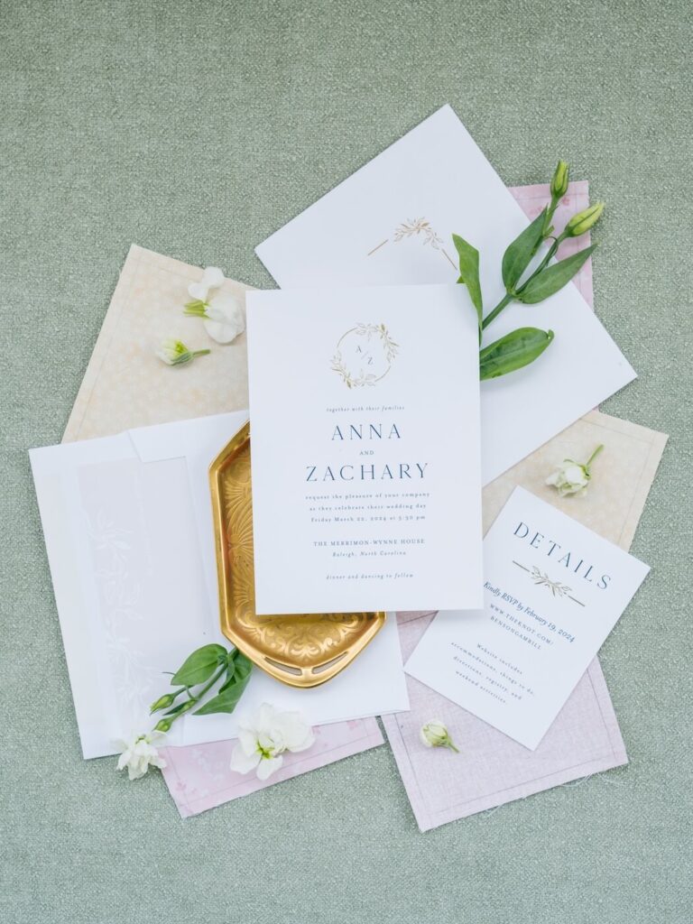 Invitation flatlay with dusty pink & greens.