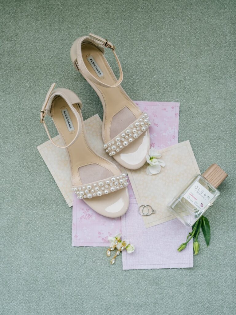 Bride details flatlay with dusty pink & greens.