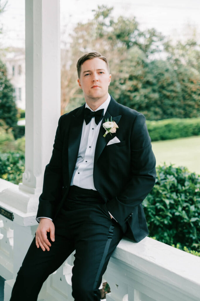 Groom waiting for first look on the porch at the Merrimon-Wynne House in Raleigh, NC.