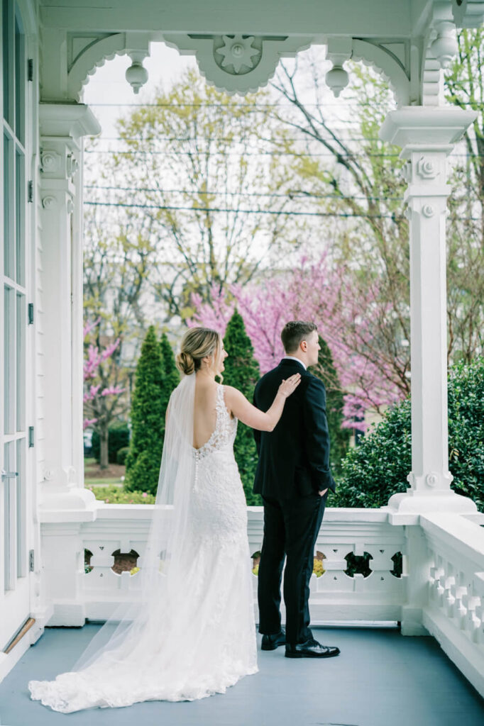 Bride and groom first look on the porch at the Merrimon-Wynne House in Raleigh, NC.