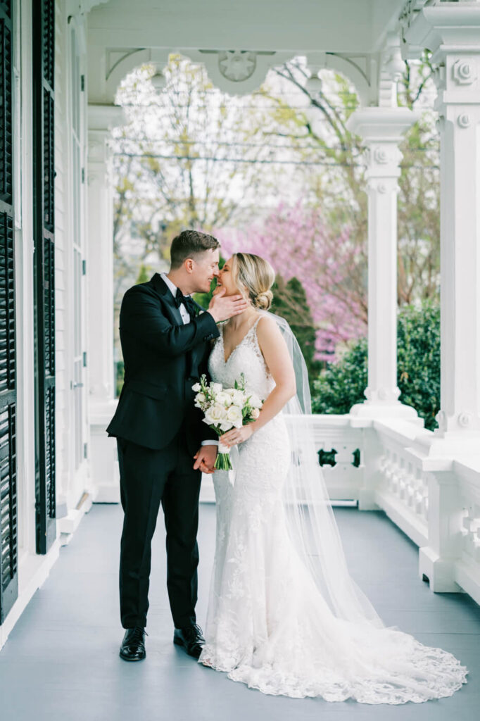 Bride and groom portraits on the Merrimon-Wynne House porch.