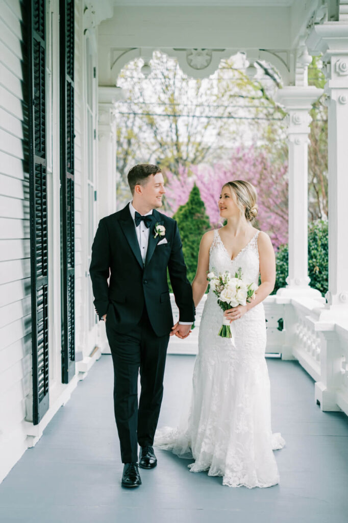 Bride and groom portraits on the Merrimon-Wynne House porch.