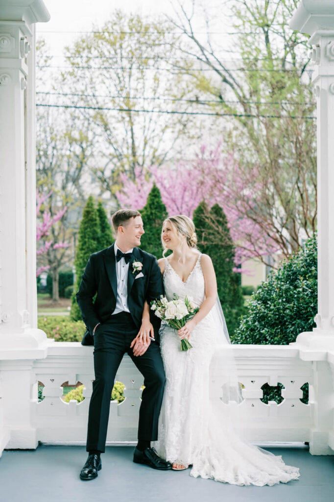 Bride and groom portraits on the Merrimon-Wynne House porch.